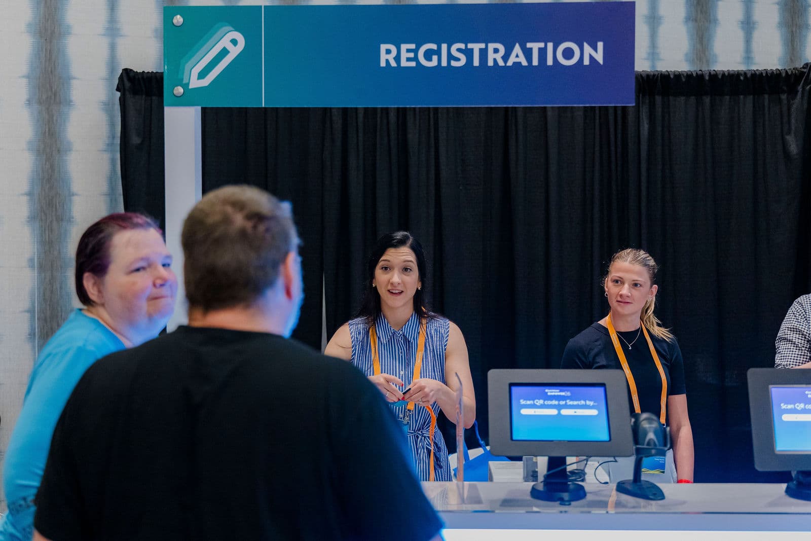 Registration desk at Empower 2026 in Austin, with staff at tablet check-in under a Registration sign